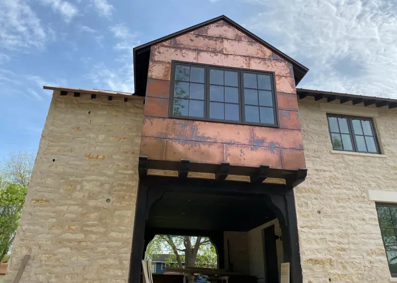 Copper metal panel facade on a stone building for Metal Roof Coating in Meadow Lakes