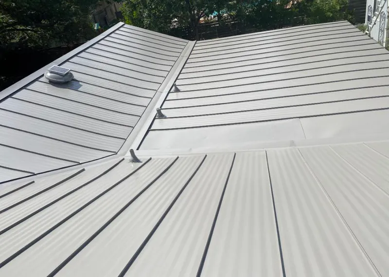 Solar attic fan installed on a metal roof for Roof Ventilation in Meadow Lakes